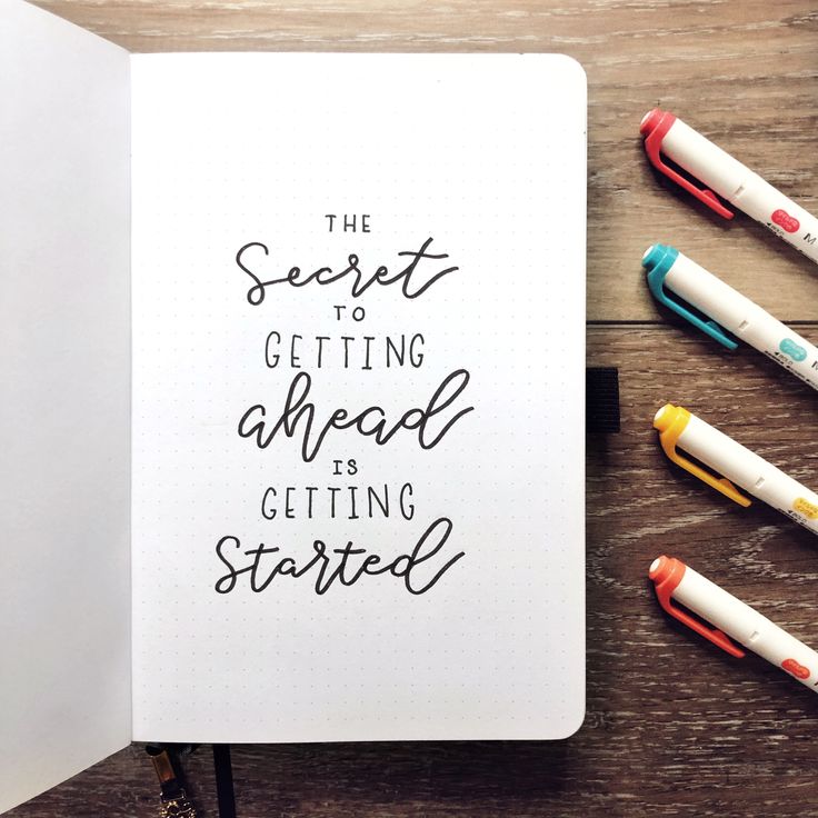 the secret to getting ahead is getting started written in a notebook with markers and pens