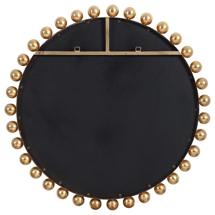 a black and gold plate with pearls on it