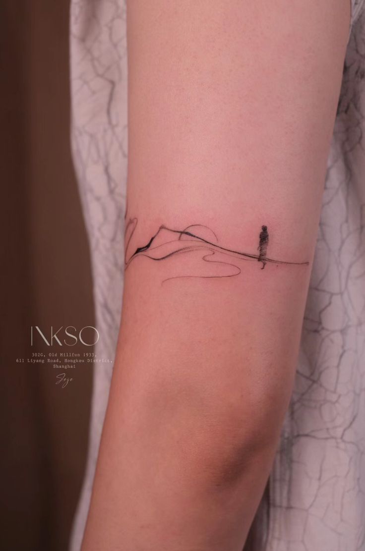 a woman with a small tattoo on her arm