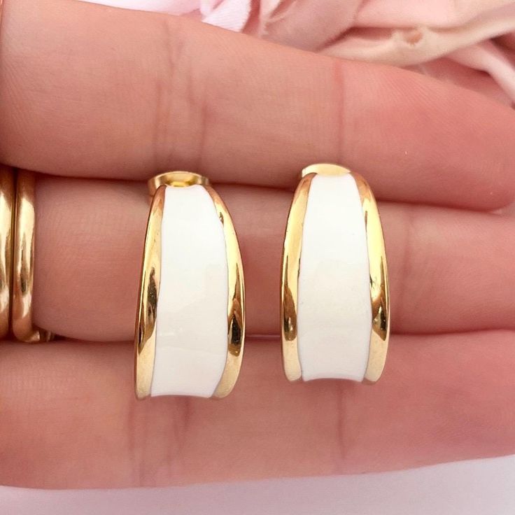 These beautiful pierced earrings are vintage from the 1980s. Gorgeous 14k gold plated chunky statement half hoop earrings. Featuring gorgeous white enamel. Length: 2cm. Width: 1cm. www.vintageamara.co.uk Hypoallergenic: The hypoallergenic property of stainless steel ensures that you can wear your jewelry without worries, even if you have sensitive skin. Water Resistant: Our finishes allow you to expose your everyday jewelry to water while keeping their shine and finishes intact. 14k Gold Plating Everyday Gold Enamel Earrings, White Enamel Hoop Earrings For Gifts, Classic White Metal Hoop Earrings, White Enamel Small Hoop Earrings, White Clip-on Hoop Earrings For Gift, White Clip-on Hoop Earrings As Gift, Everyday White Metal Hoop Earrings, White Enamel Jewelry For Anniversary, White Metal Hoop Earrings For Anniversary