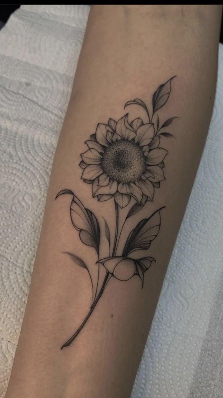 a sunflower tattoo on the arm