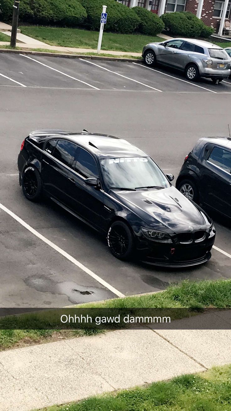 two cars parked in a parking lot next to each other