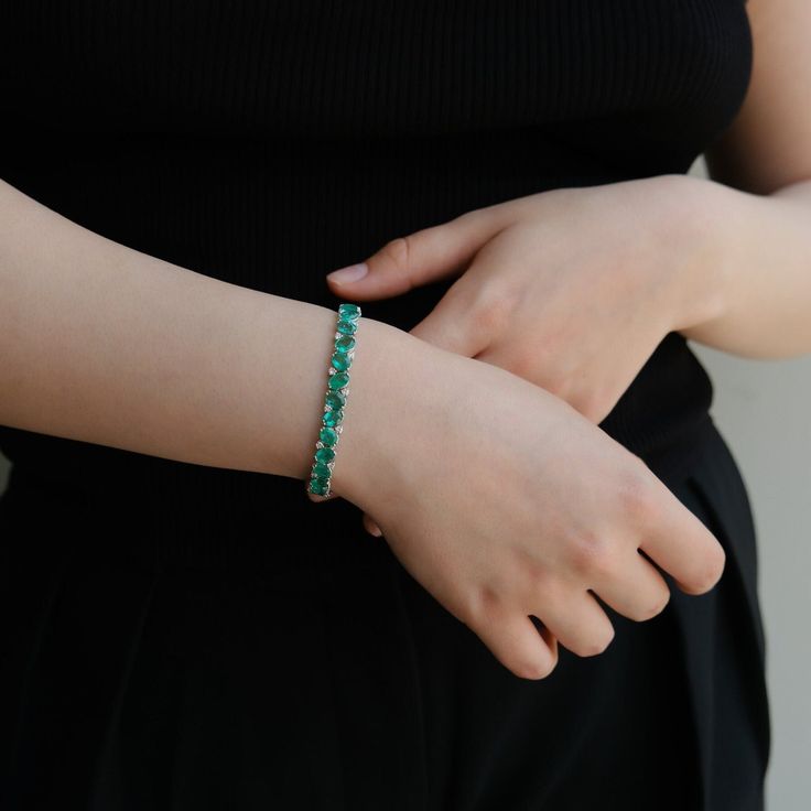 The Jewels Of Desire Cipresso Bracelet is a magnificent ode to the Mediterranean flora. Adorned with 13.27 carats of verdant pear-shaped emeralds, complimented beautifully by 1.08 carats of diamonds, this bracelet is a verdant dream come alive. Crafted in shimmering white gold, it wraps around your wrist like a gentle Mediterranean breeze. A piece from RUCHI New York's Jewels Of Desire collection, it embodies the spirit of Italy's lush landscapes, promising to be an enchanting addition to any je Luxury Green Tennis Bracelet For Formal Events, Green Diamond Bangle Bracelet For Formal Occasions, Formal Green Diamond Bangle Bracelet, Luxury Emerald Tennis Bracelet Gift, Green Gemstone Diamond Bracelet For Formal Occasions, Green Emerald Bracelets For Formal Occasions, Green Emerald Bracelets For Formal Events, Formal Green Diamond Bracelet With Gemstone, Formal Green Emerald Bracelets