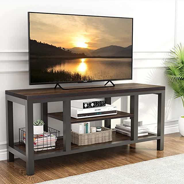 a flat screen tv sitting on top of a wooden stand