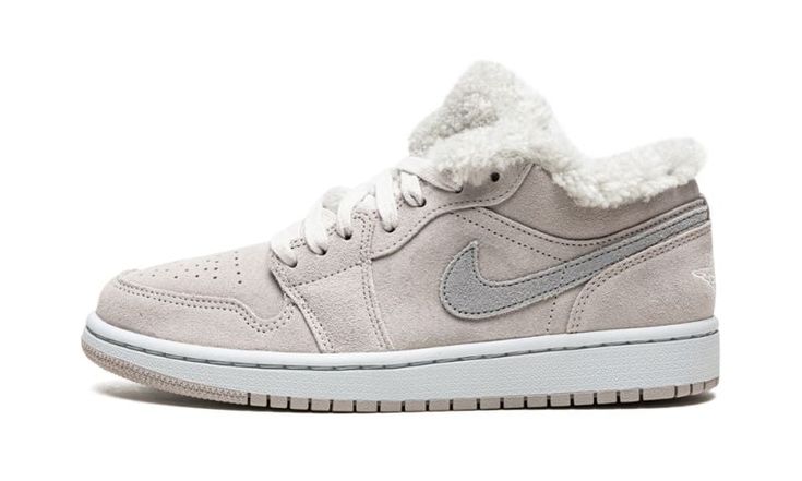 The Women’s Air Jordan 1 Low SE “Sherpa Fleece” is a women’s-only colorway of the popular lifestyle shoe with a cozy vibe that’s ideal for cooler temperatures.  The Jordan 1 Low “Sherpa Fleece” champions a decidedly off-court look with a white sherpa fleece-lined interior that wraps around the ankle collar and appears on the tongue.  The upper is constructed of grey suede.  A dark grey suede Swoosh is found on the sides and a white “Wings” logo is embroidered on the heel.  The “Sherpa Fleece”Jor Womens Air Jordan 1, Womens Air Jordan, Jordan Mid, Wmns Air Jordan 1, Gymnastics Shoes, Sneakers Box, Kobe Shoes, Retro Basketball Shoes, Womens Sherpa