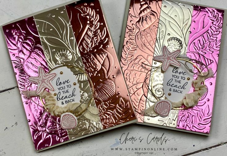 two cards with sea shells and words on them, one is pink and the other is gold