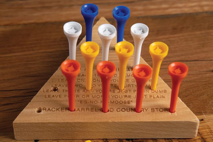 six toothbrushes are lined up on a wooden stand with words written in them