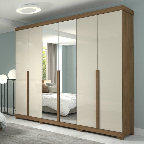 an image of a bedroom setting with mirrored closet doors