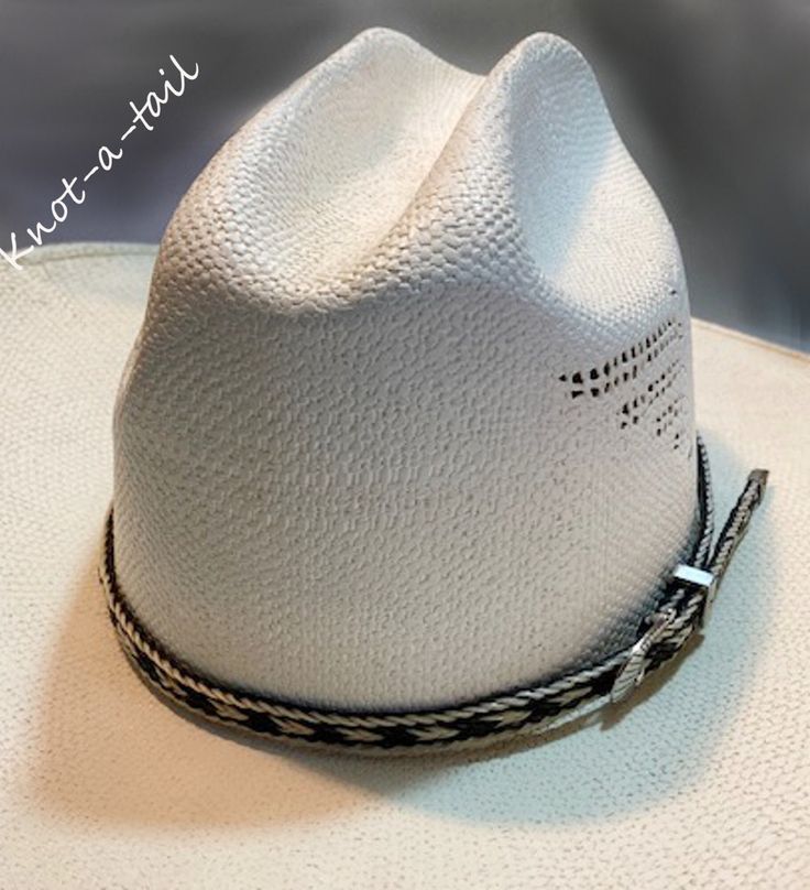 This horsehair hat band is    IMPRESSIVE!  EXTREMELY BOLD  The outside is done in a creamy white rich  BLACK horsehair inside  with creamy white trim With a 3 piece buckle set-  fancy Southwest design.  Unique, distinctive and exceptional quality. Everything you want in a Horsehair hat band. because this one brings out your spirit in an exclusive design that is vibrant as your western  lifestyle.             MEASUREMENTS * Longest length 25 inches * Shortest length about 15 inches or less if nee Classic White Straw Hat For Ranch, White Fitted Country Straw Hat, White Fitted Country Style Straw Hat, White Western Straw Hat With Short Brim, White Western Style Straw Hat With Short Brim, White Straw Hat With Short Brim For Ranch, White Straw Hat For Ranch, Western White Panama Hat For Kentucky Derby, White Western Fedora Panama Hat