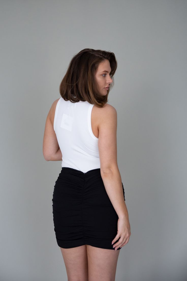 Our Naia Mini Skirt features a mini length, asymmetric cut, ruching on the side front and back of the garment with invisible zipper, This garment has lining and no stretch. 95% Polyester, 5% Elastane • This item fits small to size. We recommend buying one size up. • Model is 5'8 and wearing size L. Ruched Asymmetrical Draped Skirt For Night Out, Asymmetrical Ruched Draped Skirt For Night Out, Ruched Elastane Mini Skirt, Ruched Asymmetrical Skirt For Night Out, Fitted Asymmetrical Draped Skirt With Ruched Sides, Chic Fitted Skort With Gathered Skirt, Chic Ruched Draped Skirt With Stretch, Stretch Gathered Mini Skirt For Night Out, Chic Asymmetrical Skirt With Ruched Sides