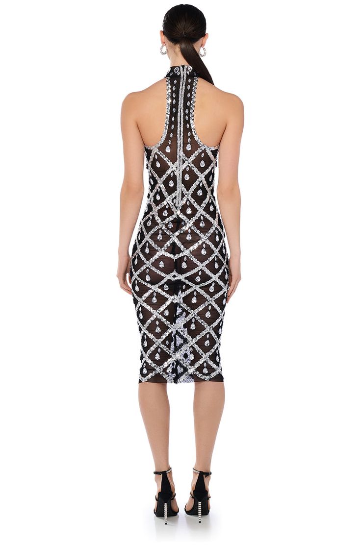 The crystal craze is here to deliver. The AKIRA Label Diamonds Are Forever Mesh Midi Dress In Black is brought to you in a sheer unlined mesh base fabrication and features a mock neck, a sleeveless silhouette, a flattering bodycon design, a midi length, and a tonal back zipper closure. Complete with sequin embellished metallic criss-cross patterning and teardrop crystal rhinestone accents throughout. Pair with nude undergarments for a seamless look. Shown undergarments not included. - Shell: 100% Polyester - Machine Wash Cold - Super Stretchy - Imported (all measurements are approximate from size small) - 52” Neck to Hem - 15” Chest Diameter - Model is 5’11.5” Product ID: 386995 Bodycon Design, Diamonds Are Forever, Mesh Midi Dress, Crystal Rhinestone, Criss Cross, Midi Length, Mock Neck, Midi Dress, Mesh