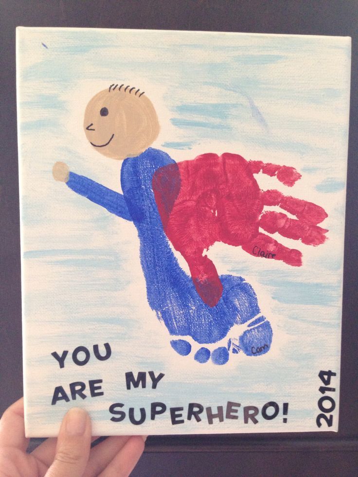 a child's hand is holding up a card that says, you are my superhero