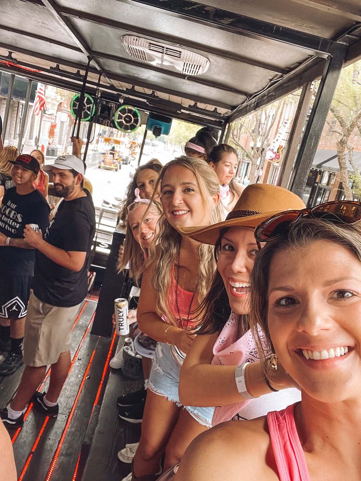 a group of people riding on the back of a bus