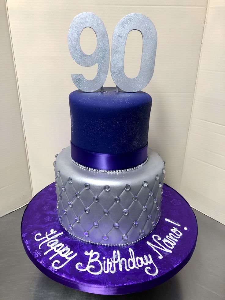 a purple and silver birthday cake with the number 90 on top