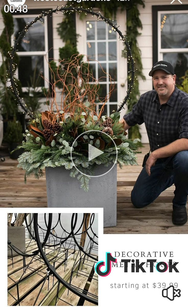 a man kneeling down next to a planter filled with succulents and plants