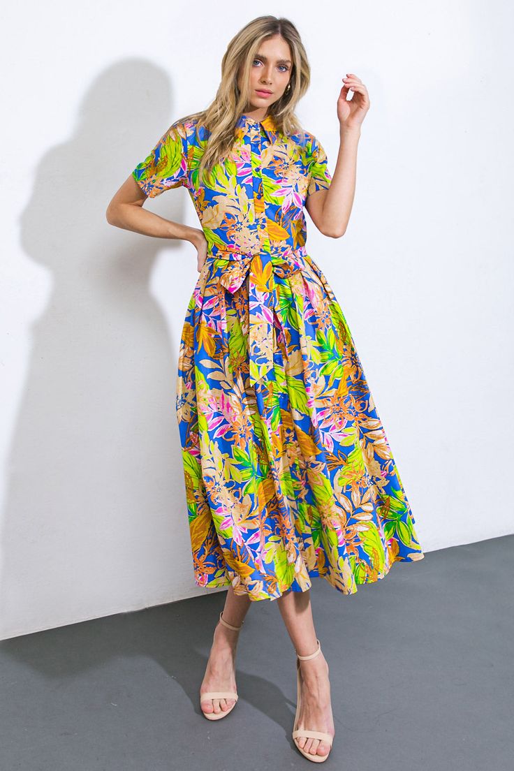 Indulge in the opulent sophistication of our printed woven midi skirt dress, adorned with cuffed short sleeves, a button-down front, and a self sash tie.Details:Self : 100% CottonSize & Fit- Model is 5`8" And Wearing Size Small- Measurements Taken From Size Small- Approx. Length: 49" Spring Shirt Dress With Tie Waist For Casual Days, Spring Shirt Dress With Tie Waist For Casual Occasions, Spring Shirt Dress With Tie Waist For Casual Wear, Casual Spring Shirt Dress With Tie Waist, Multicolor Floral Print Shirt Dress For Work, Belted Blue Shirt Dress For Summer, Spring Knee-length Shirt Dress With Tie Waist, Knee-length Shirt Dress With Tie Waist For Spring, Daywear Floral Print Midi Dress With Short Sleeves