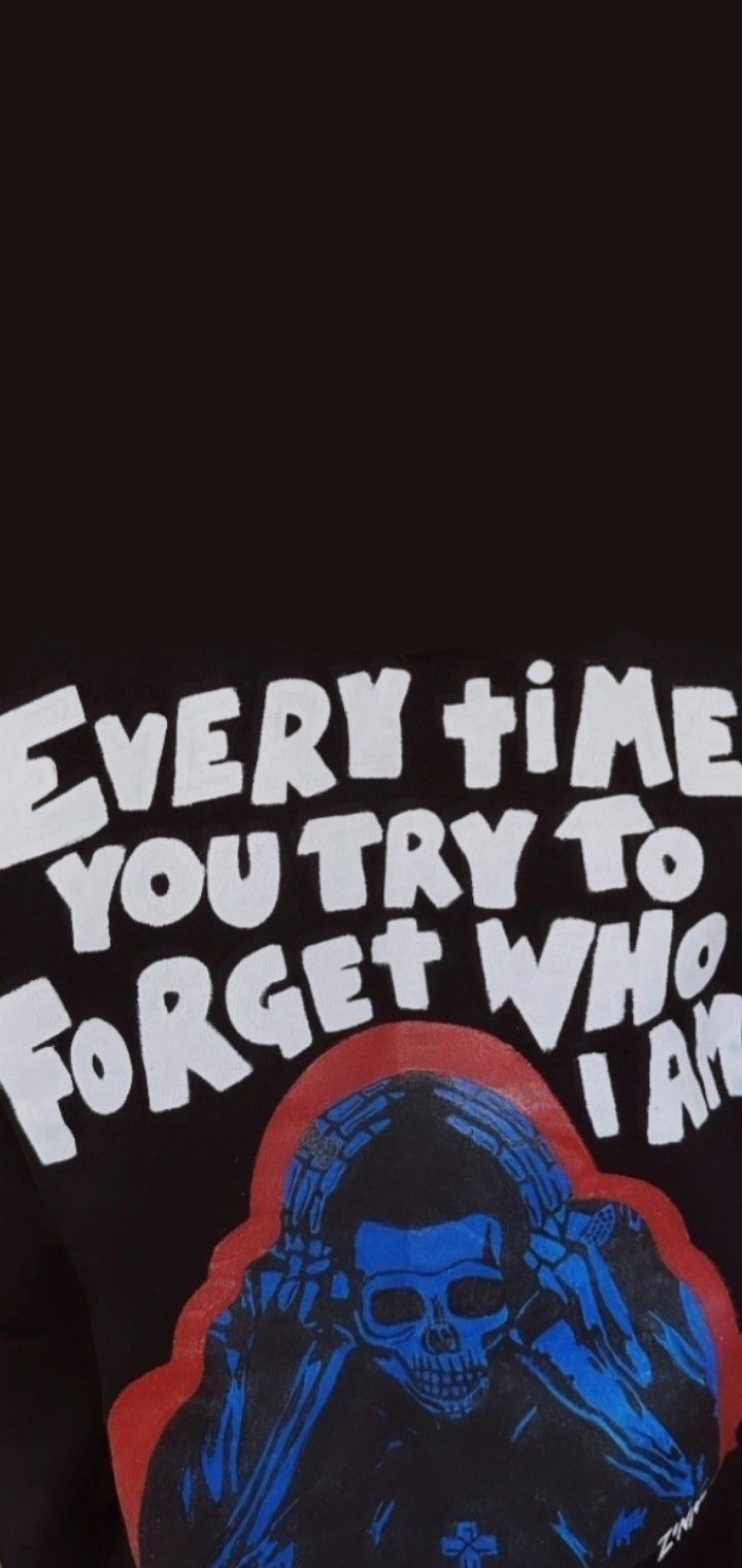 the back of a black shirt with a blue skull on it and words that read, every time you try to forget who i am