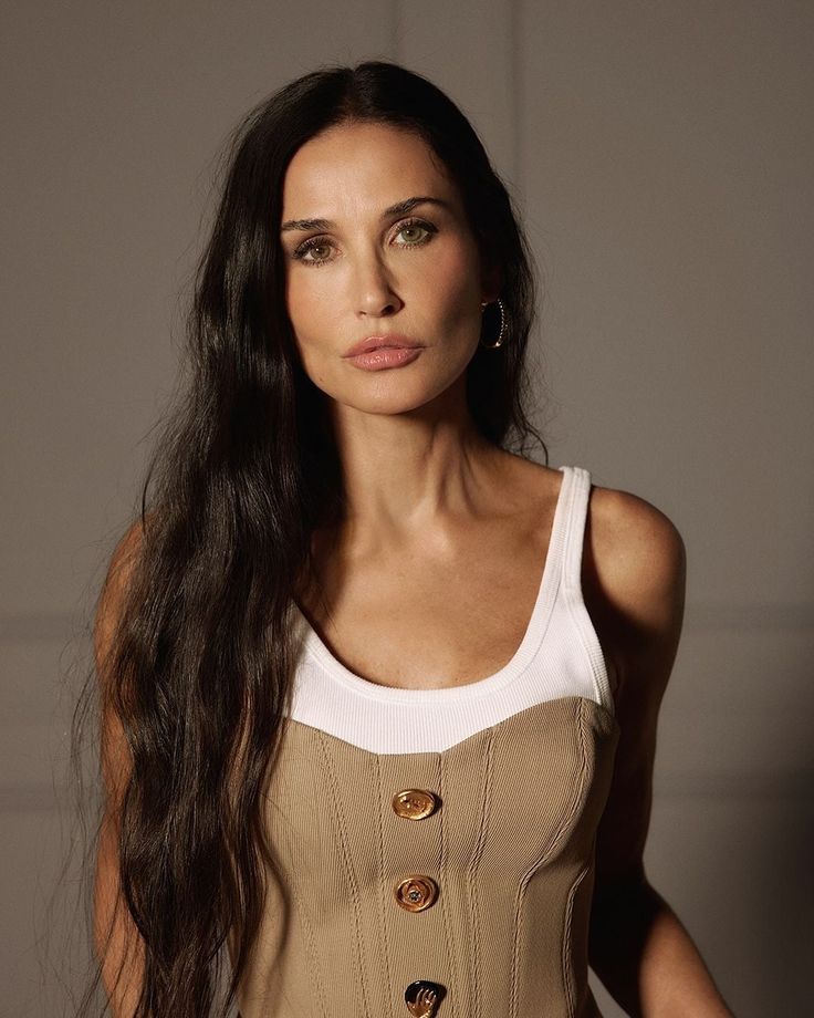 a woman with long hair wearing a tan corset