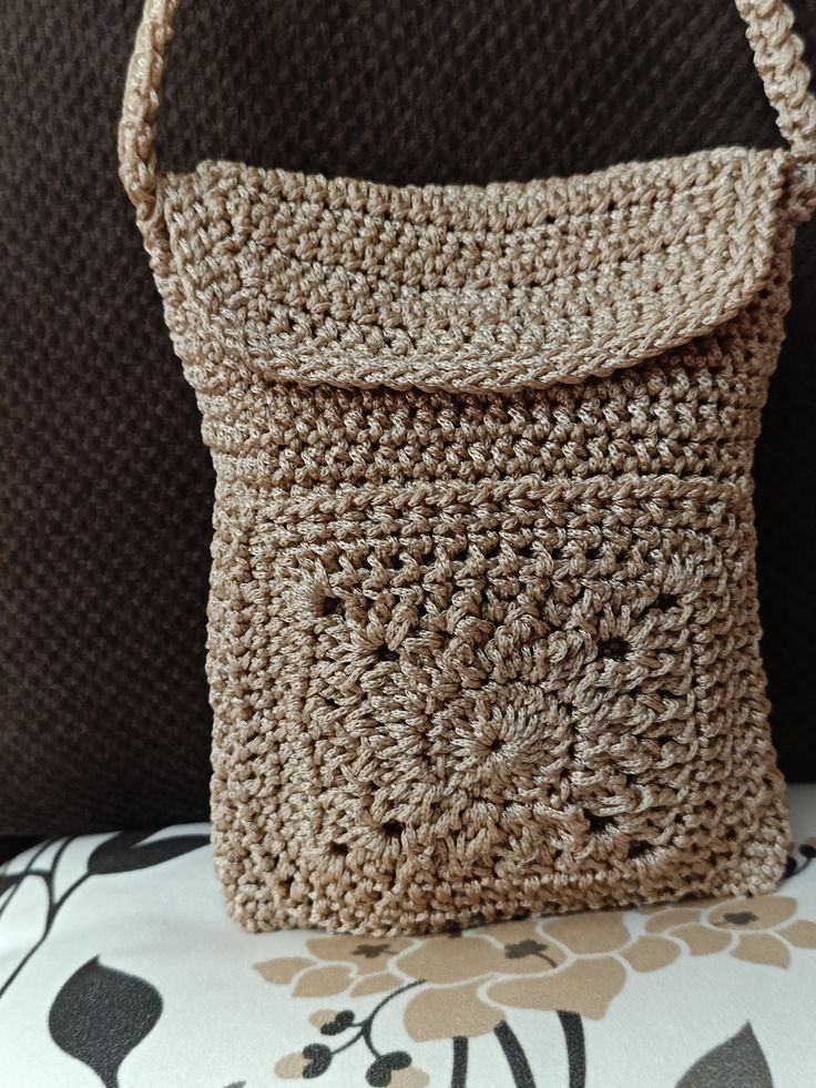 a crocheted purse sitting on top of a couch