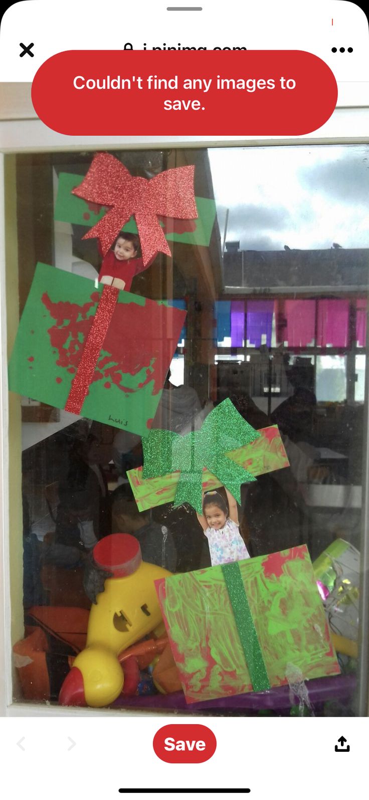 a child's artwork is displayed in a window