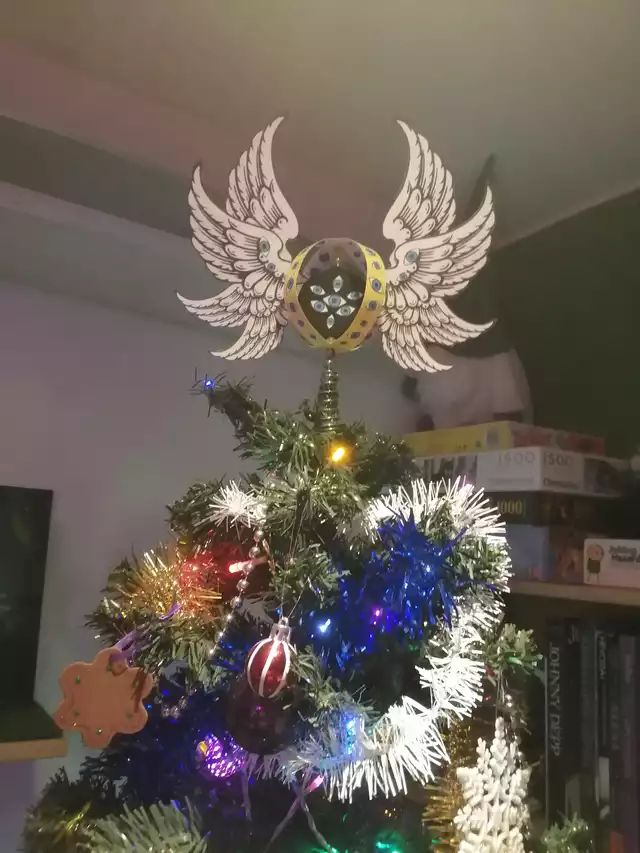 a christmas tree with angel wings on top