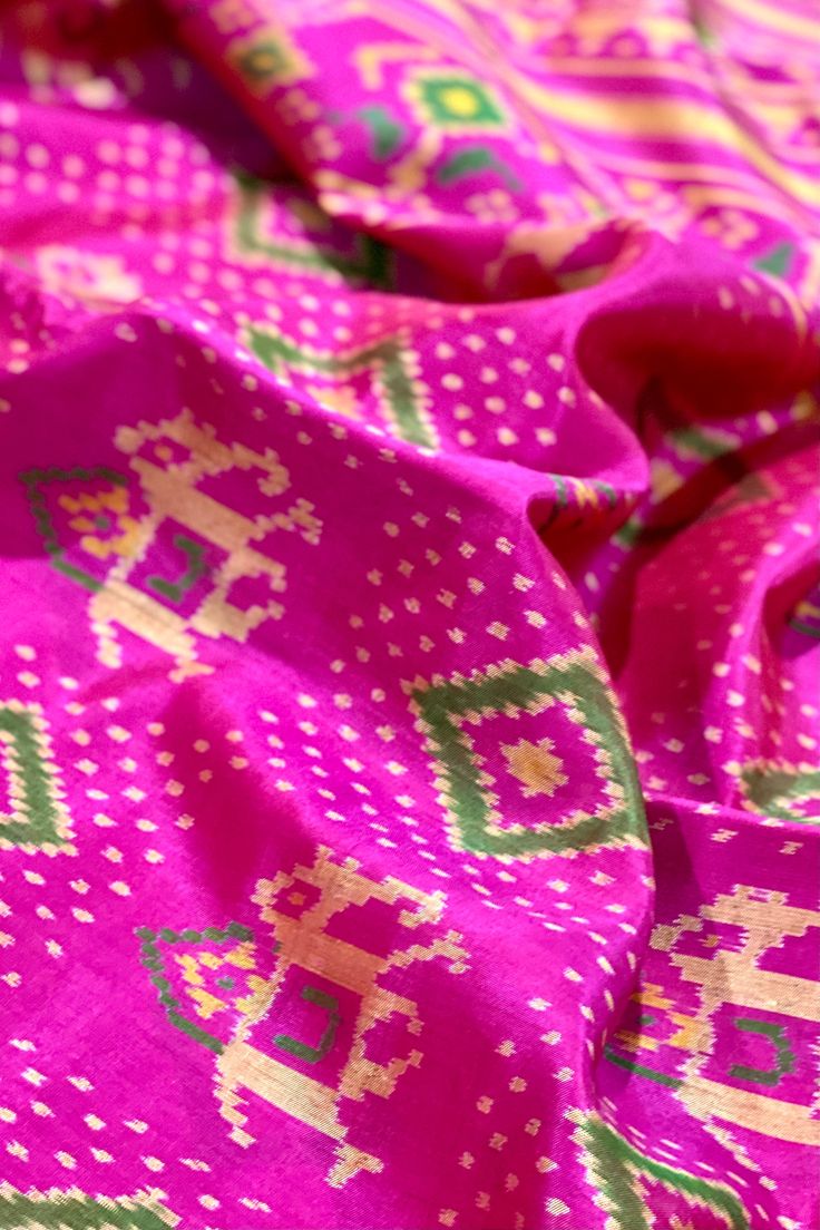 This beautiful single ikkat Patola saree in pink color is woven in narikunj design. The borders are woven in antique gold tissue with the ikkat design, and the pallu has a beautiful floral patterns. Approximate Length 6.5 mtrs (inclusive of blouse length)Height - 46 - 50" Saree comes with fall, picot and tassels done. Blouse piece is cut. Approximate weight - 1.2 lbs Kindly Note : The colors you see on your device may vary due to the color reproduction, brightness and resolution of individual devices. If you'd like more clarity before your purchase, please contact our support team. Designer Pink Slub Silk Traditional Wear, Pink Slub Silk Dupatta For Designer Wear, Pink Bandhani Print Pre-draped Saree For Festivals, Multicolor Ikat Print Pre-draped Saree For Navratri, Designer Pink Slub Silk Lehenga, Pink Slub Silk Pre-draped Saree With Dupatta, Unstitched Pink Slub Silk Traditional Wear, Pink Blouse Piece With Bandhani Print In Traditional Drape, Pink Blouse Piece With Bandhani Print