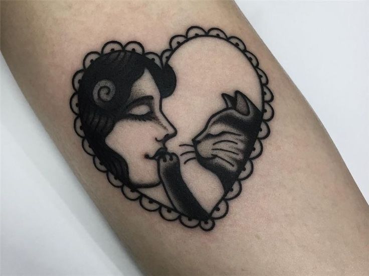 a woman's face in a heart shaped frame with a cat on her arm