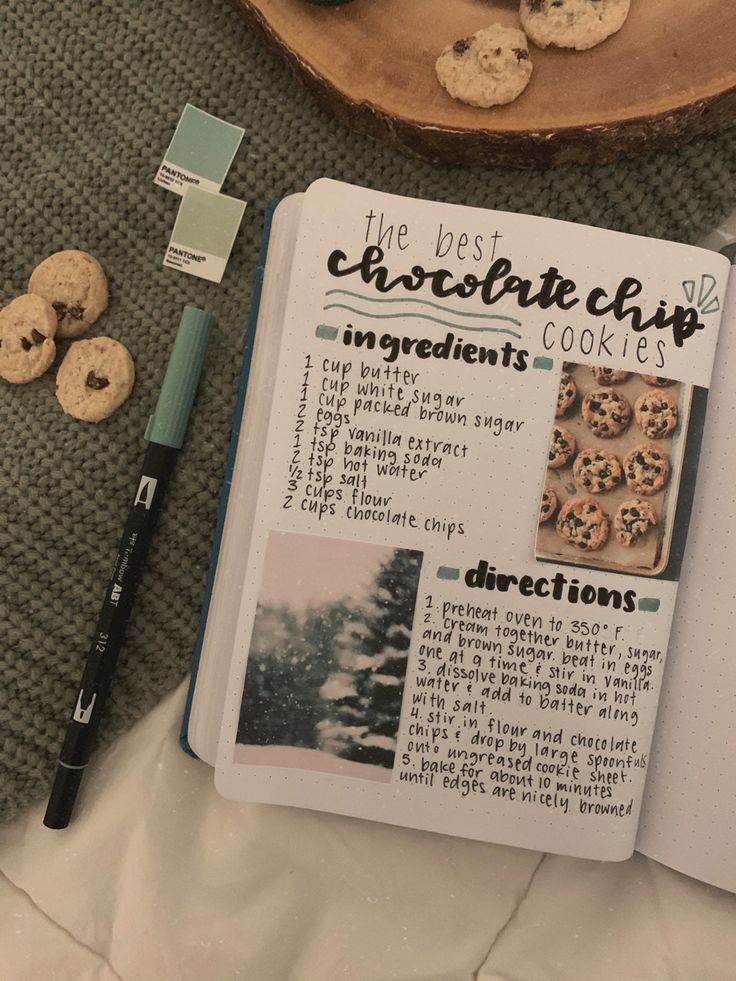 a recipe book with cookies on it next to a pen and some other food items