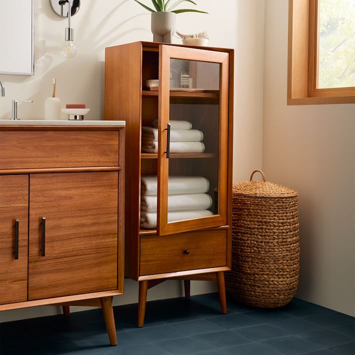 a wooden cabinet sitting next to a bathroom sink