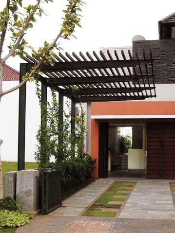 an entrance to a house with a pergolated roof