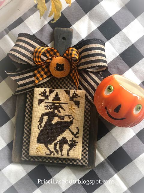 an orange pumpkin sitting on top of a table next to a black and white checkered cloth