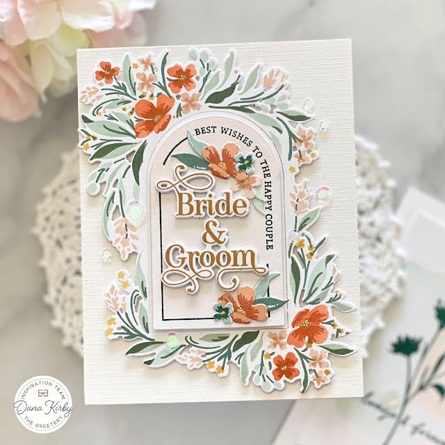 a wedding card with flowers on it and the words bride and groom written in gold