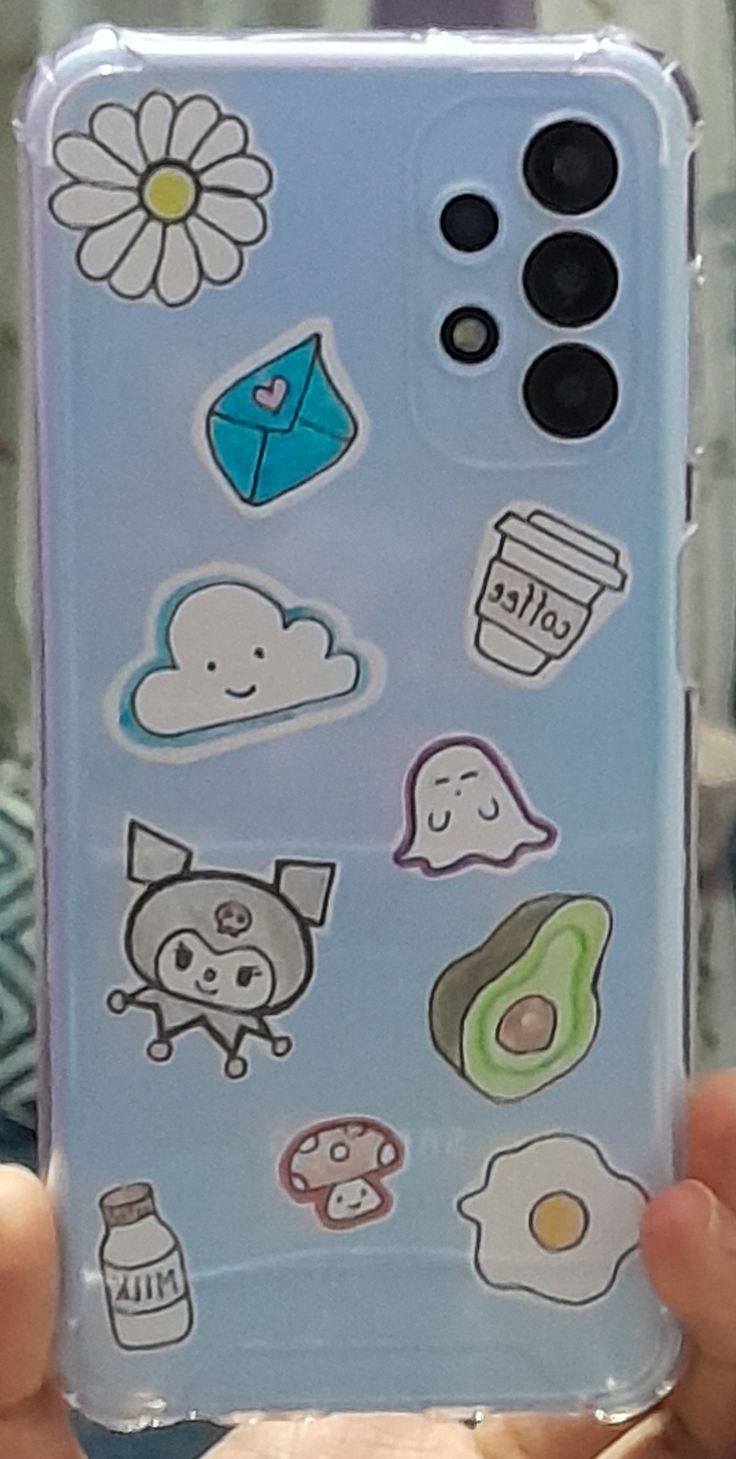 someone holding up their phone case with stickers on it's back and side