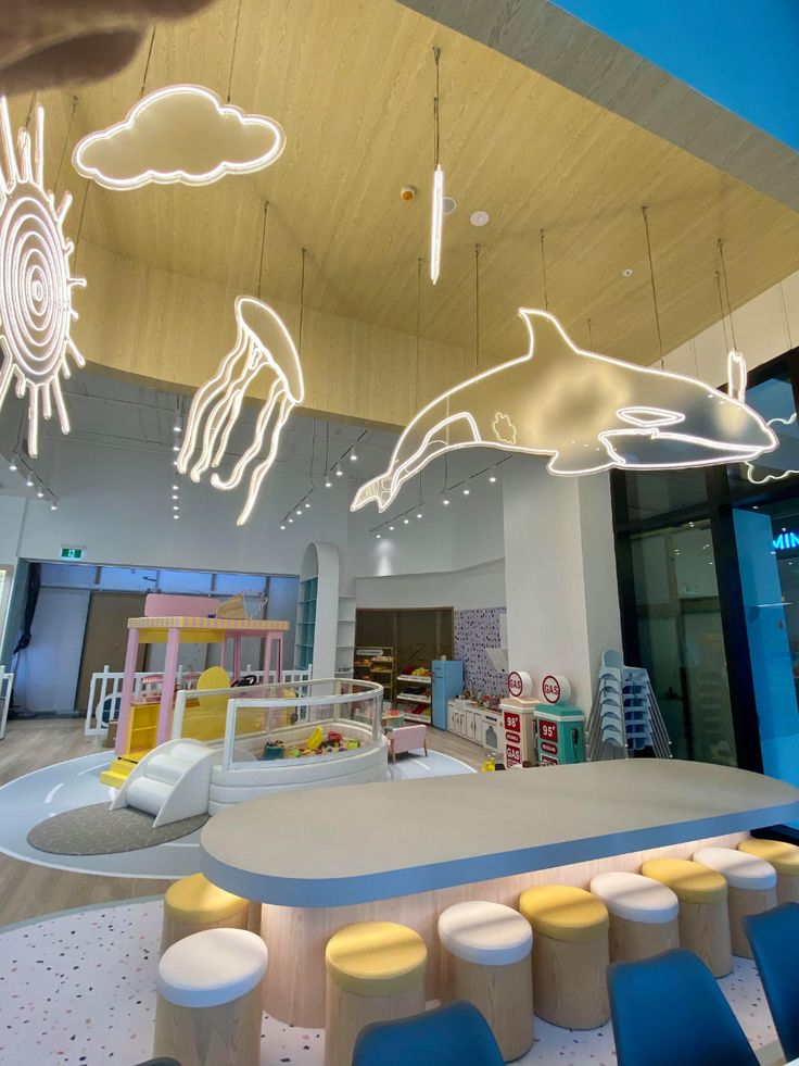 the interior of a children's playroom with lights and furniture