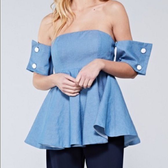 Light Denim Color Off Shoulder Top With Detailed Button Cup Sleeves. Back Zip And Lined. Chic Short Sleeve Denim Top For Day Out, Denim Top With Buttons For Day Out, Fitted Short Sleeve Denim Top With Buttons, Denim Blue Tops With Button Closure For Spring, Spring Denim Tops With Button Closure, Spring Denim Top With Button Closure, Spring Denim Blue Tops With Button Closure, Chic Fitted Button-up Denim Top, Spring Medium Wash Tops With Button Closure