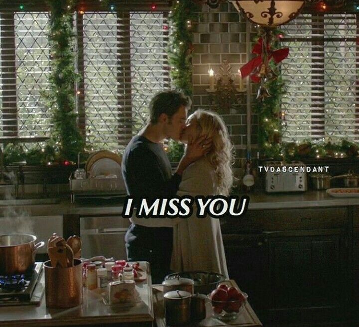 a man and woman standing in front of a kitchen counter with the words i miss you