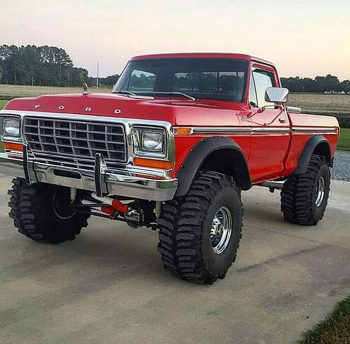 a red truck parked on top of a cement road