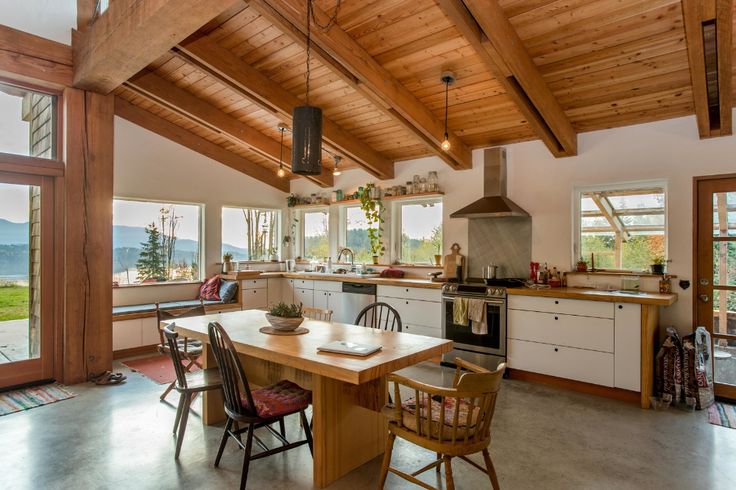 an open kitchen and dining area with wood ceilinging