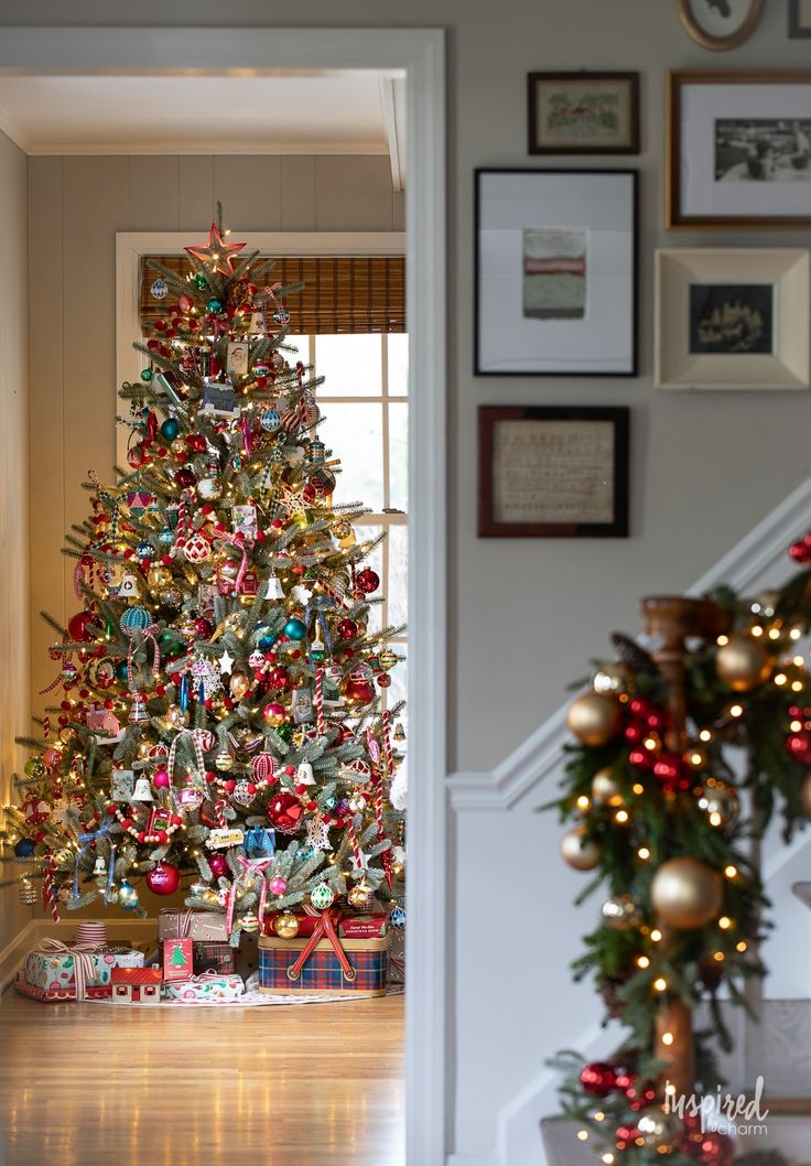 a decorated christmas tree sitting in the corner of a room