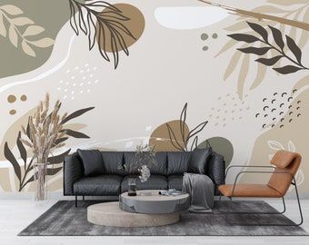 a living room with a couch, chair and wall mural