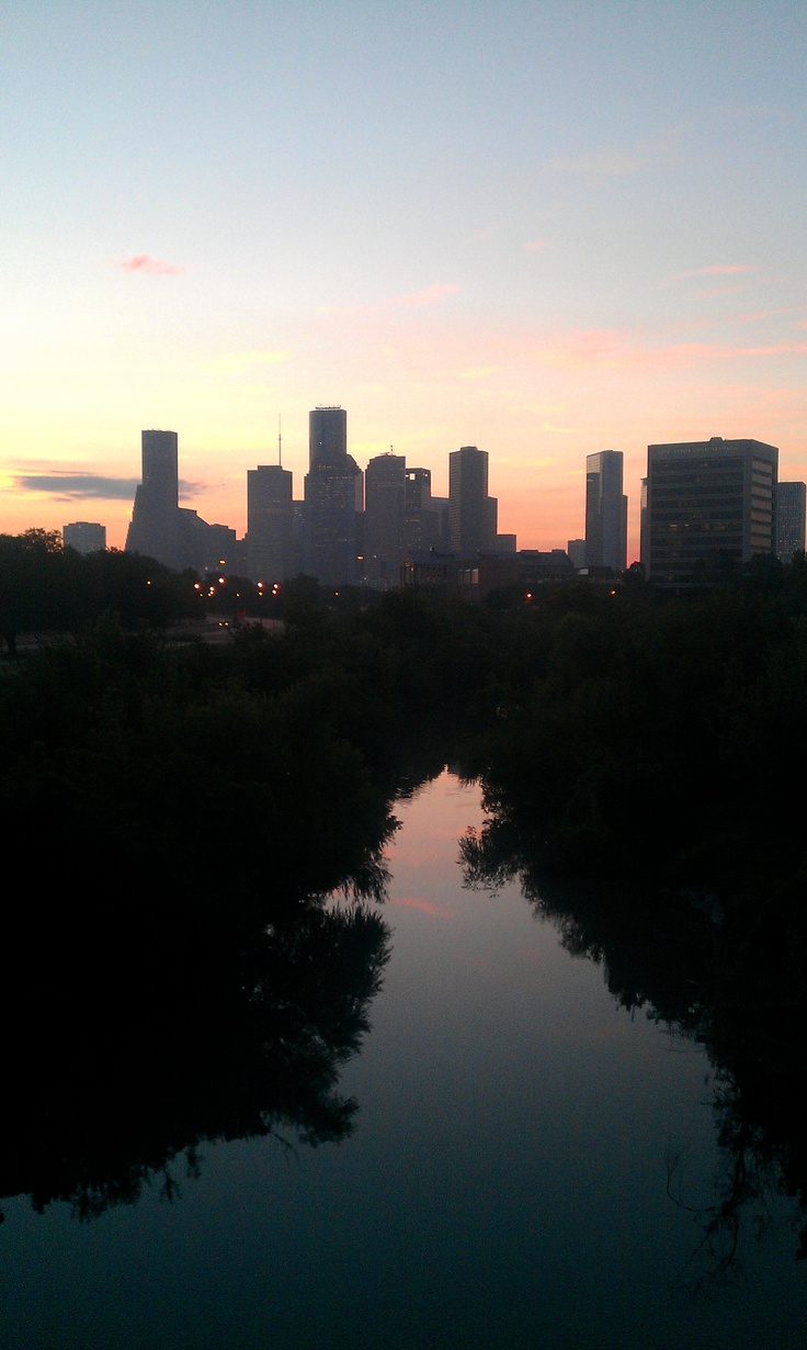 the city skyline is reflected in the water