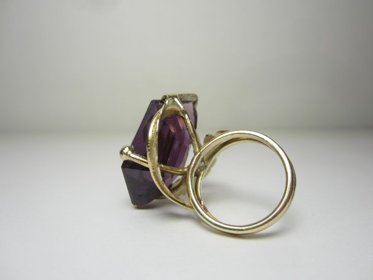 "This completely unique and one of a kind ring was purchased from the estate of a jewelry designer who made many custom and unique pieces in our local area around Cleveland, Ohio in the 70's and 80's. The 14k gold setting features a split ring shank and gold leaves that circle around and beneath the gigantic gemstone. The gemstone is a violet-blue to purple color-change sapphire in a free form cut. Gemstone Dimensions - 27mm x 18mm x 9.5mm Ring Size 5.5. (Can easily be resized to most sizes) Mar Modern 14k Gold Collectible Jewelry, 14k Gold Jewelry With Unique Design For Formal Occasions, Formal 14k Gold Jewelry With Unique Design, Collectible Modern 14k Gold Jewelry, Unique 14k Gold Rings With Polished Finish, Modern Yellow Gold Collectible Rings, Modernist Hallmarked 14k Gold Jewelry, Formal Fine Jewelry With Unique Design, Modernist 14k Gold Ring Jewelry