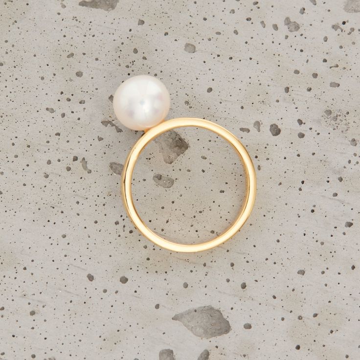 Lily 18K gold vermeil ring with freshwater pearl. Pearl Width: 8mm Band Width: 2.5mm Nickel free 2.5 microns of gold vermeil Base metal is recycled sterling silver Handcrafted in high polish MYW05GV198PL Modern Yellow Gold Pearl Promise Ring, Modern 14k Yellow Gold Pearl Ring, 14k Yellow Gold Rings With Pearl Charm, Modern Round Pearl Ring In Yellow Gold, Yellow Gold Open Ring With Pearl Drop, Gold Akoya Pearl Ring, Minimalist Akoya Pearl Round Ring, Gold Pearl Drop Ring In Classic Style, Minimalist Gold Pearl Ring For Anniversary