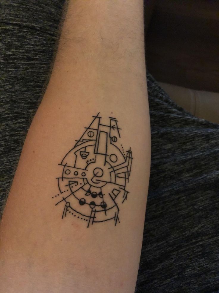 a person with a tattoo on their arm that has an image of a clock in it