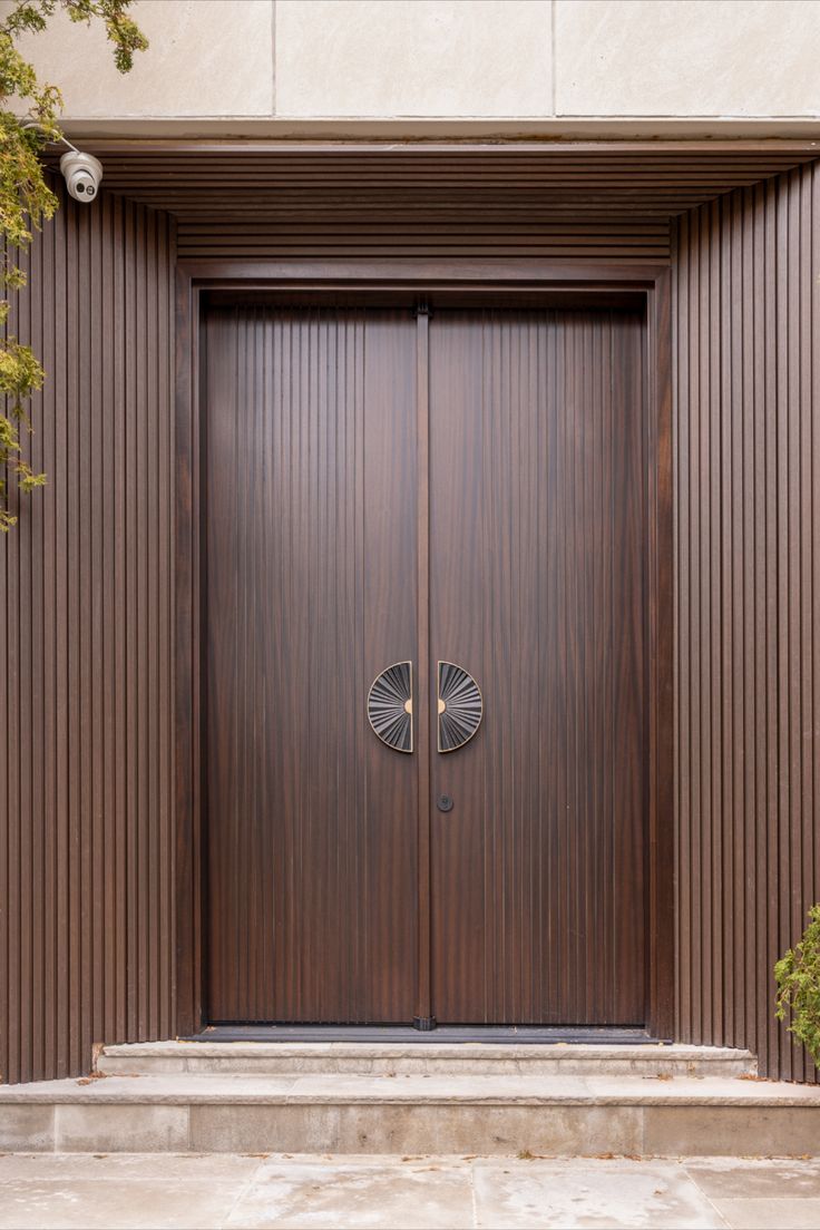 a large wooden door in front of a building