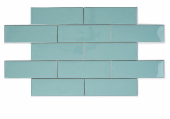 a light blue tile wall that has been made from glass tiles and is being used as a