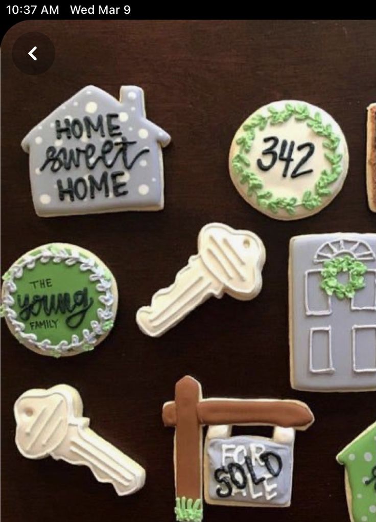 decorated cookies are displayed on a table for someone's home sweet home birthday party