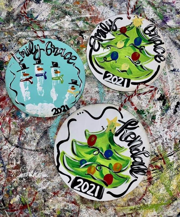 three buttons with christmas trees painted on them