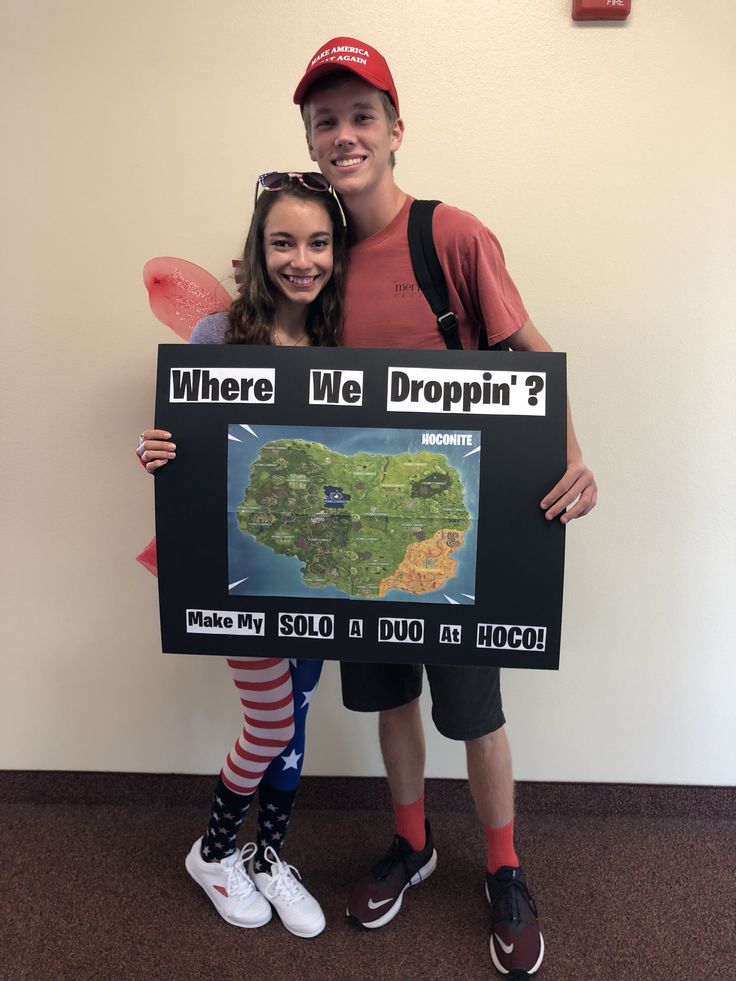 two people standing next to each other holding up a sign that says where we dropin?