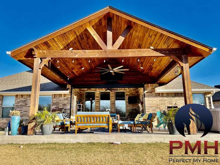 a covered patio with chairs and tables in front of it